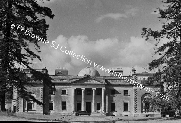 FRONTAL VIEW OF HOUSE WITH CLOUDS FROM AVENUE